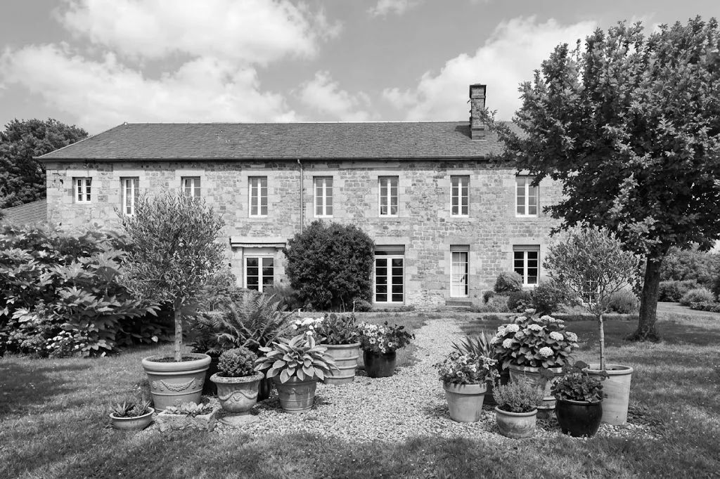 A stone French manor house with landscaped gardens